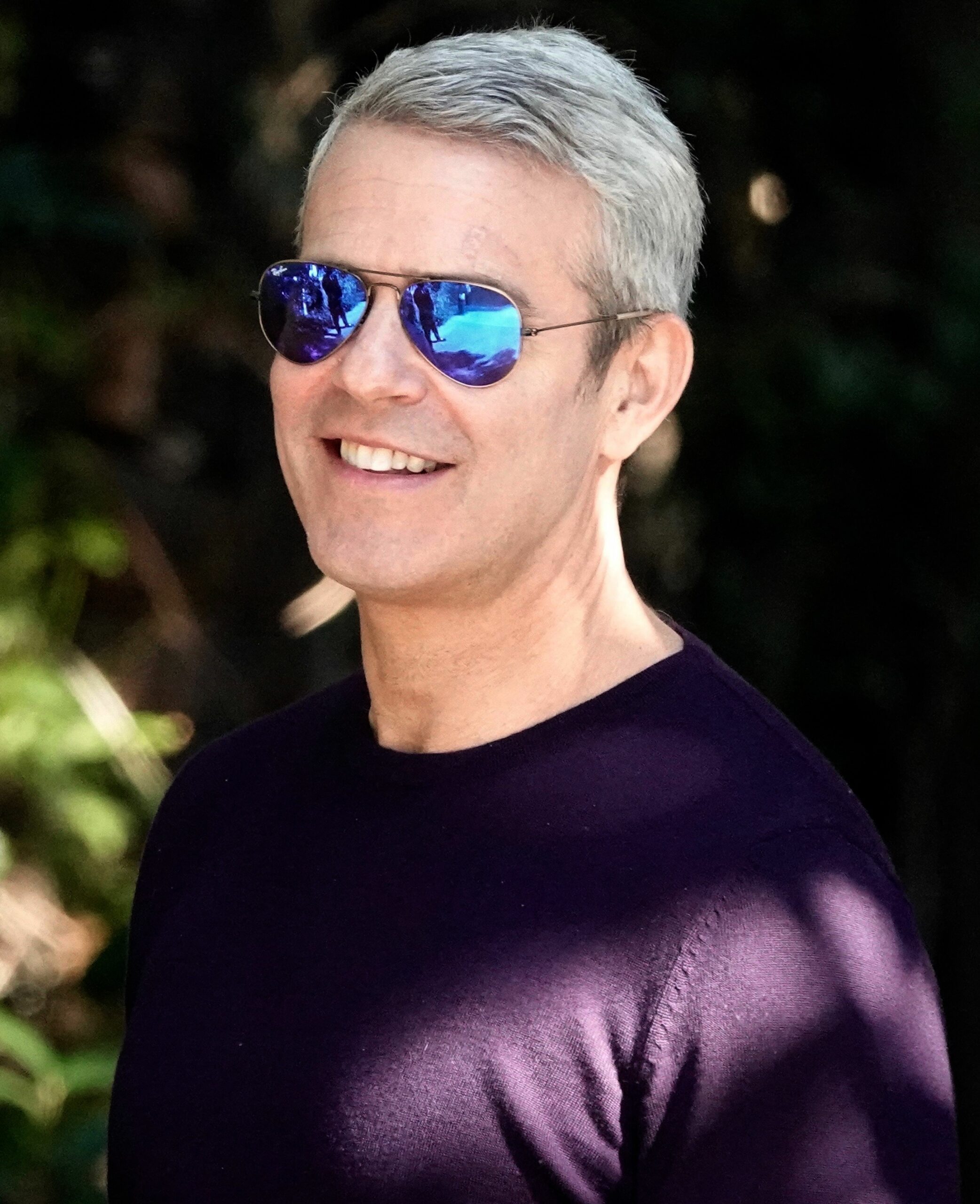Talk show host Andy Cohen and an unknown male are seen canoodling and laughing as they leave a party in Beverly Hills