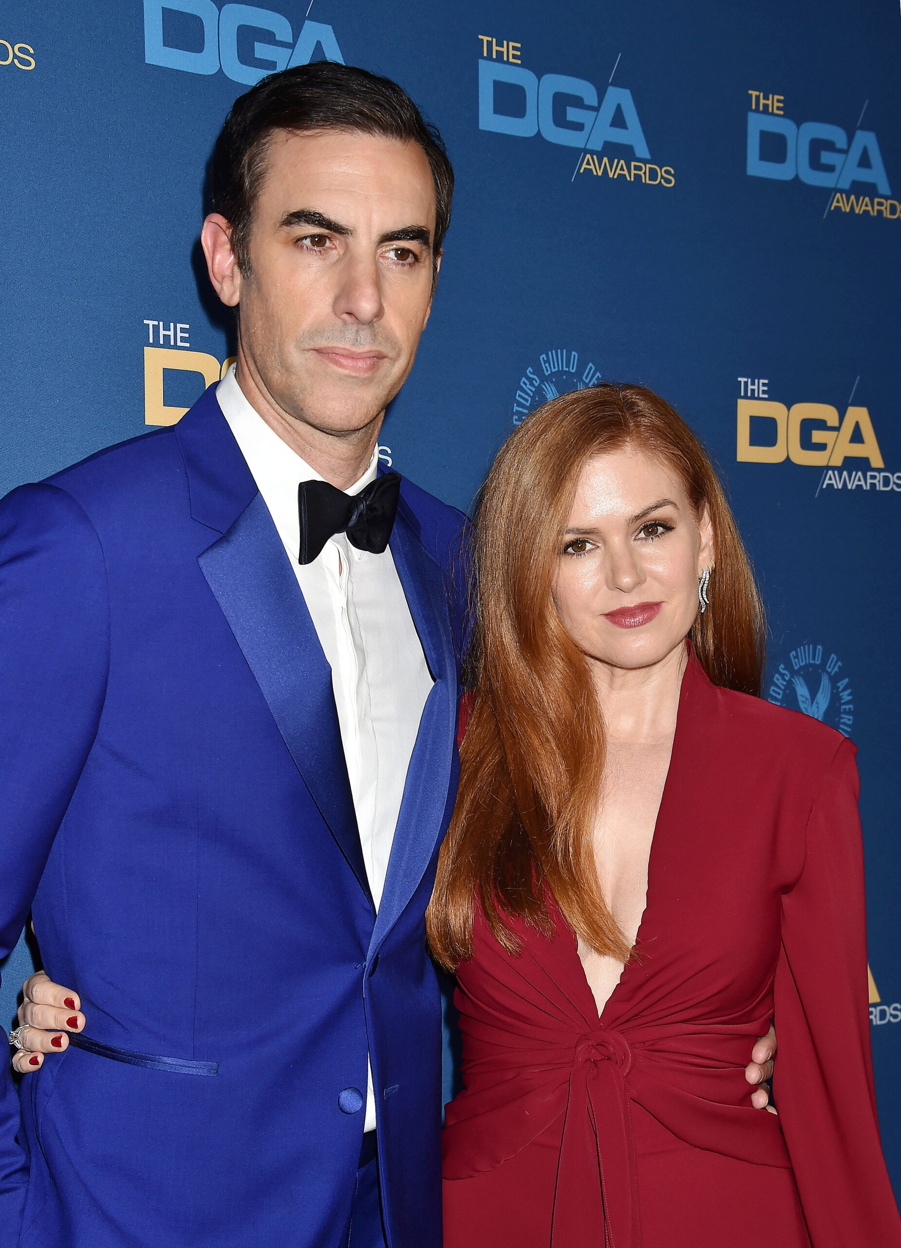 Sacha Baron Cohen and Isla Fisher smiling.