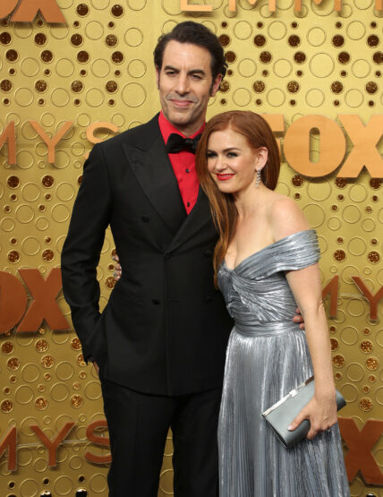 Sacha Baron Cohen and Isla Fisher smiling.