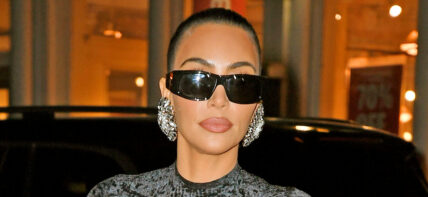 Kim Kardashian shows off her famous curves in a black dress