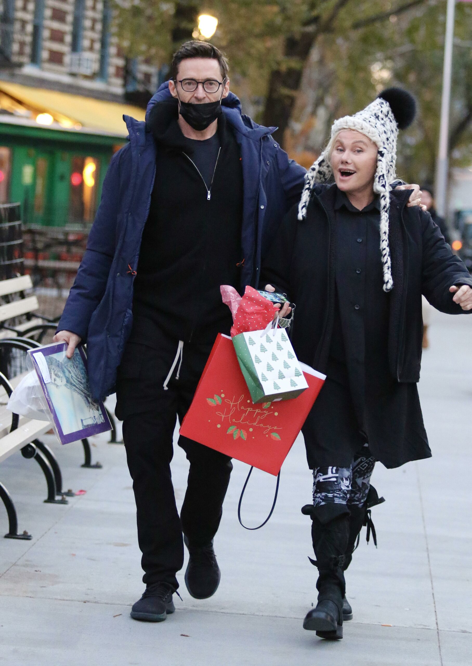Hugh Jackman and wife Deborra-Lee Furness carry early Christmas presents and a copy of Elton Johns EMPTY SKY debut studio album after having a late lunch in NYC