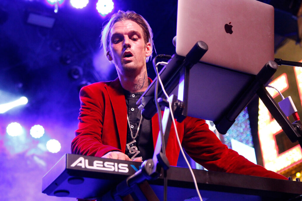 Aaron Carter performing on stage.