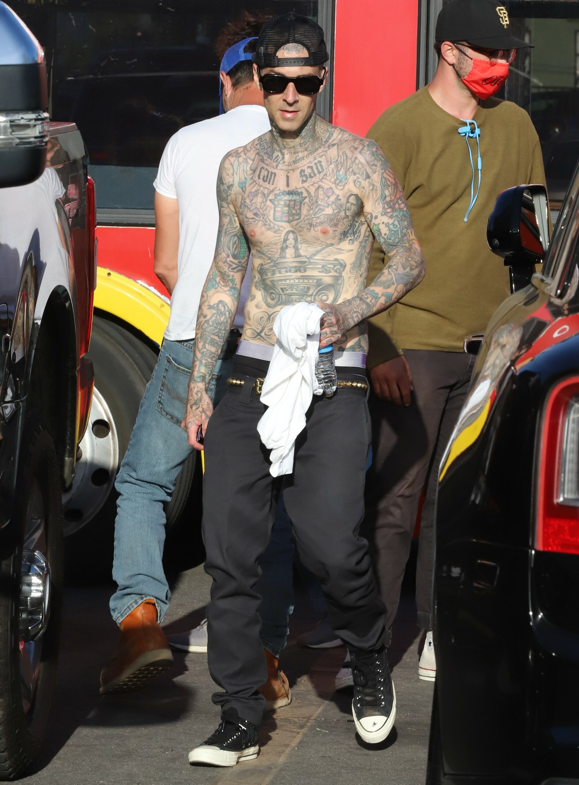 Travis Barker seen sporting a new Kourtney Tattoo over his heart as he plays the drums for a video on top a Hollywood tour bus