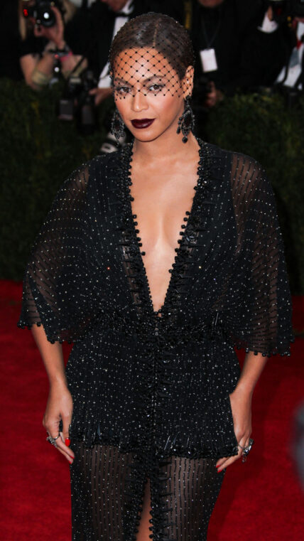 Singer Beyonce wearing a Nicolas Jebran dress, Christian Louboutin shoes, and Lorraine Schwartz earrings arrives at the 2014 MTV Video Music Awards