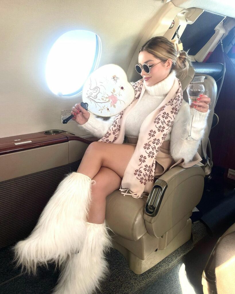 Demi Rose sitting in a helicopter.