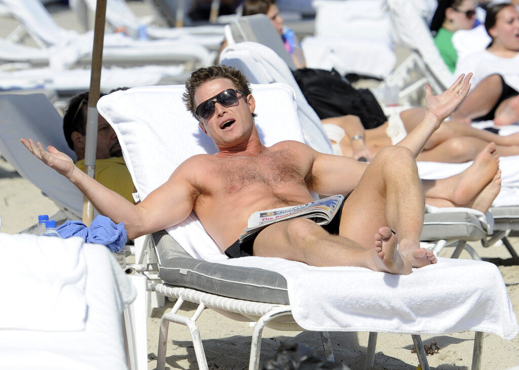 Billy Bush is seen relaxing on the beach with a friend during NATPE 2012 at the Fontainebleau Resort in Miami Beach