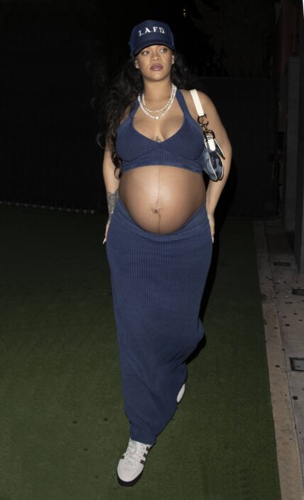 Rihanna shows off her huge baby bump while wearing denim and an LAFD hat at Nobu in West Hollywood