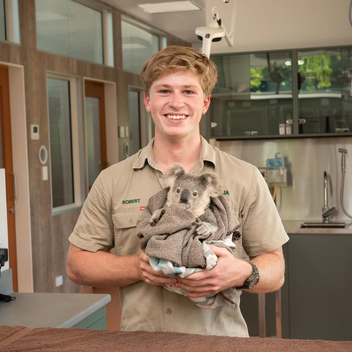 Robert Irwin and a koala at the Australia Zoo