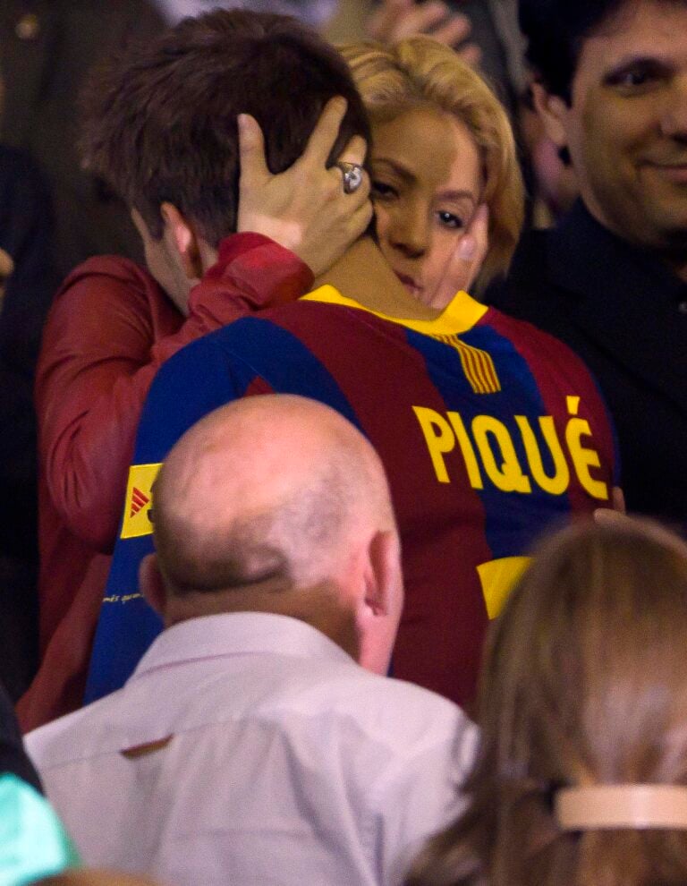 Shakira wearing a Barcelona soccer jersey interacting with fans at an event