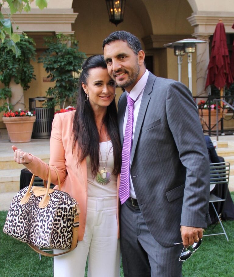 Kyle Richards and a man posing together at an outdoor event venue