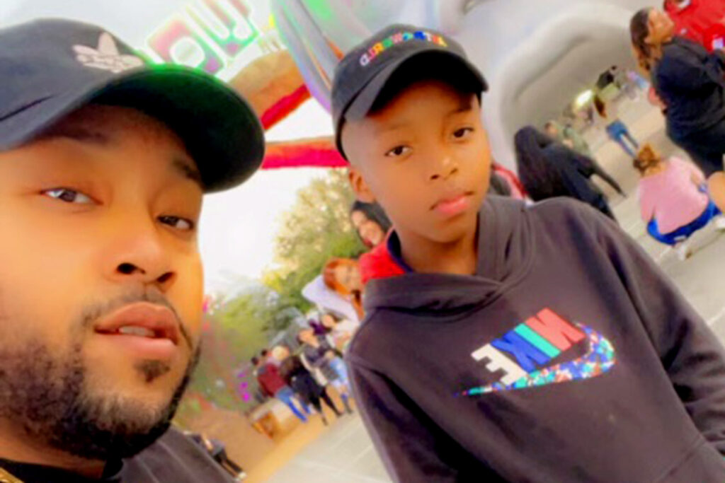 young boy and older man looking at camera