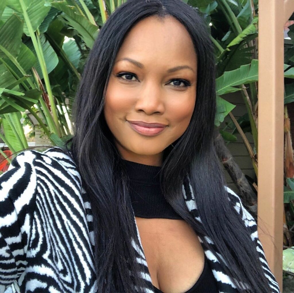 woman smiling with plants in the background