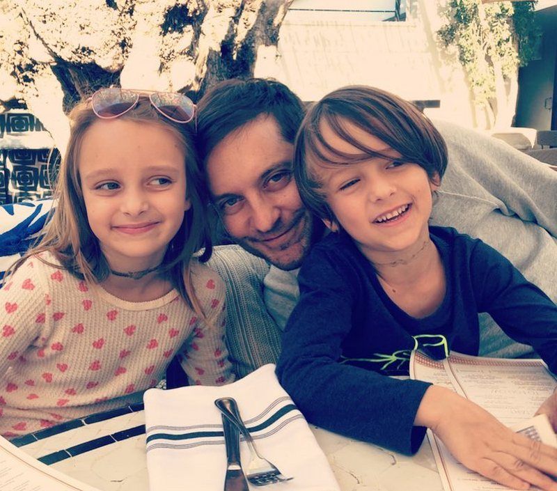 man and kids smiling for photo