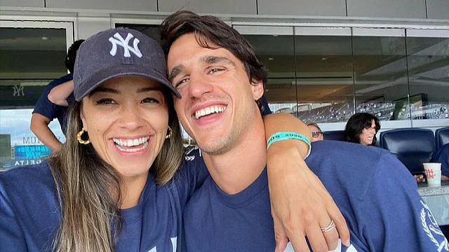 woman and man wearing matching clothes, smiling