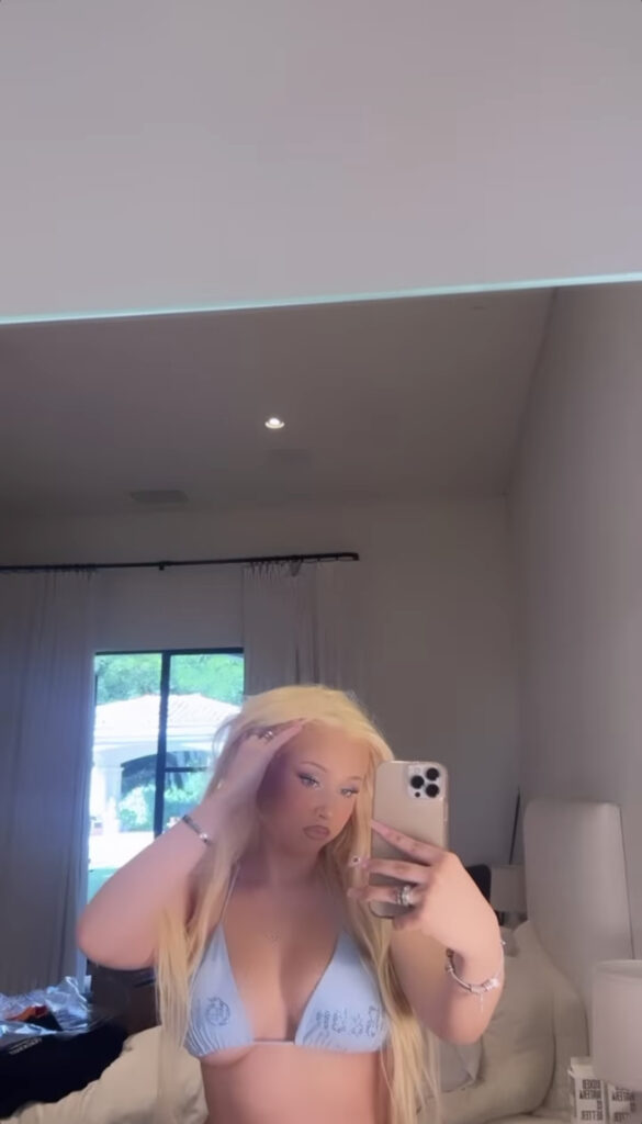Alabama Barker taking a selfie inside her room.