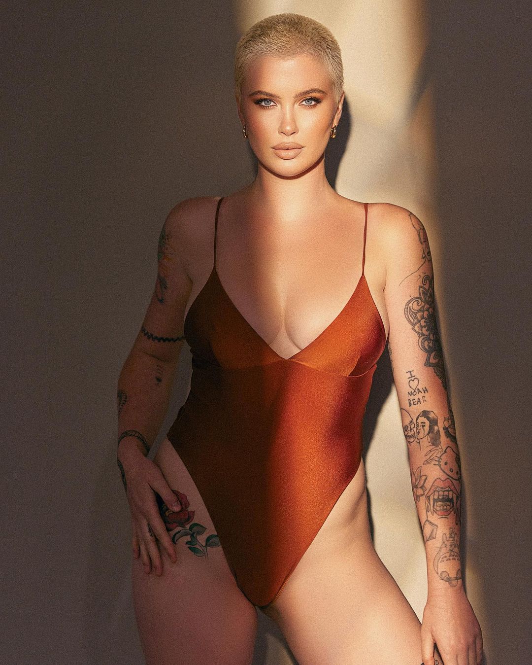 Ireland Baldwin in a burnt orange one-piece bathing suit 
