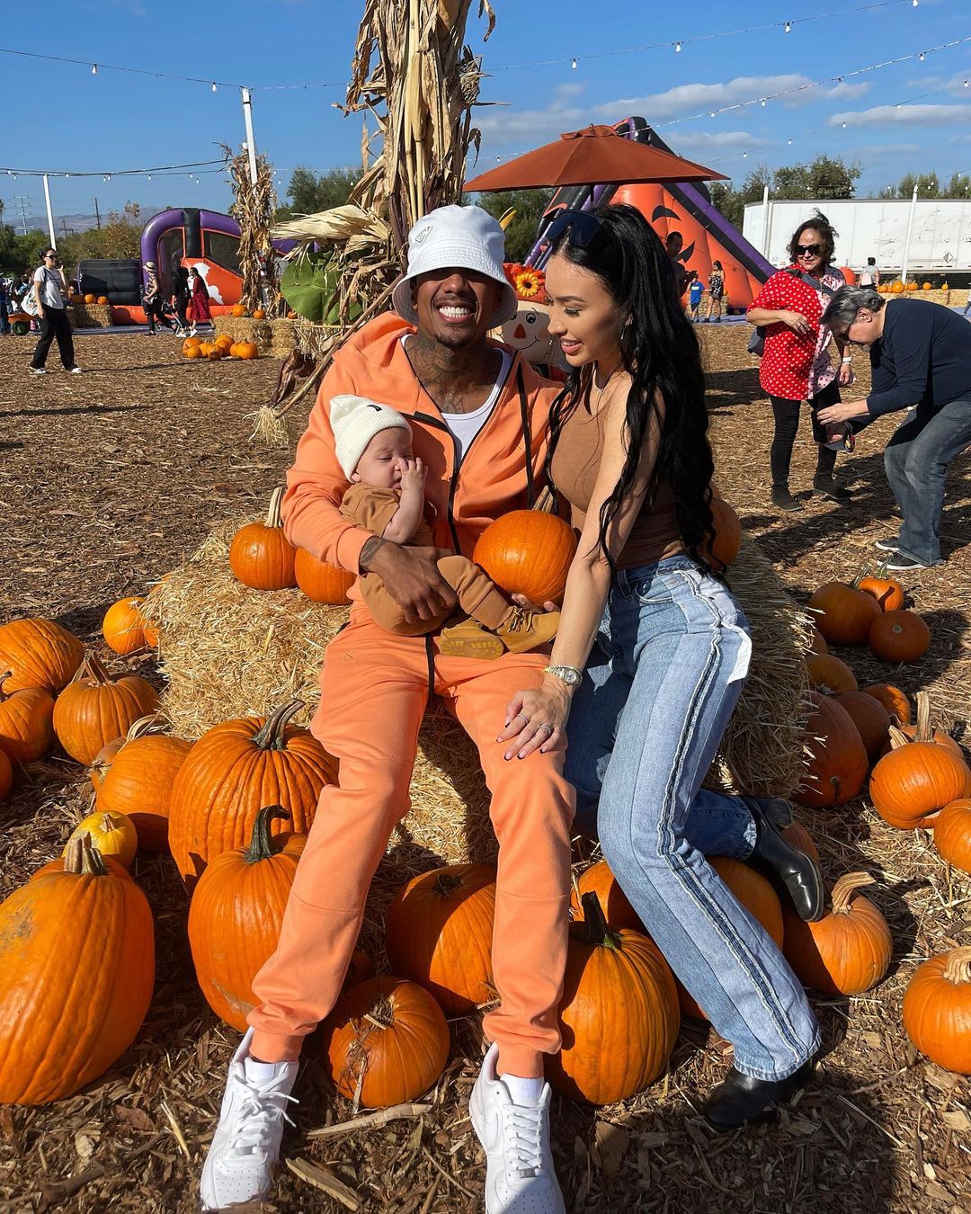 Bre Tiesi & Nick Cannon with their son at pumpkin patch