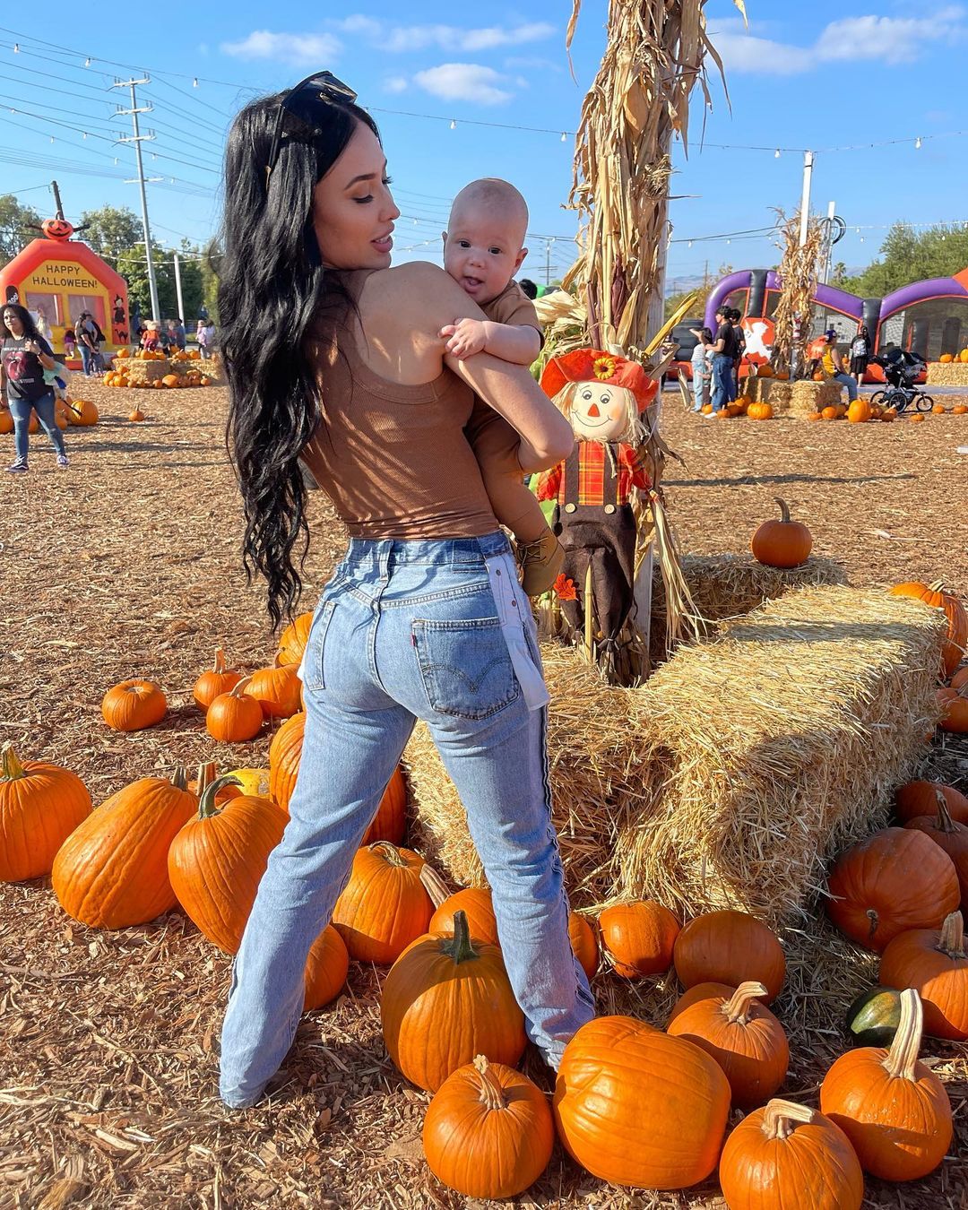 Bre Tiesi & Nick Cannon with their son at pumpkin patch