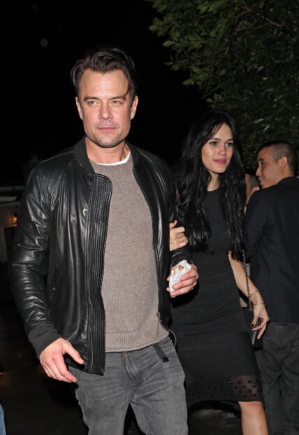 Josh Duhamel holds hands with Audra Mari as they leave a house party together