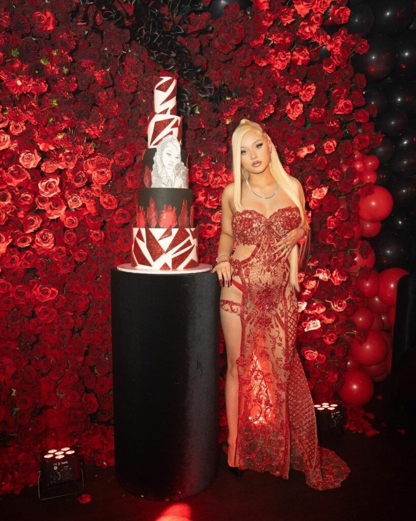 Alabama Barker posing with her birthday cake.