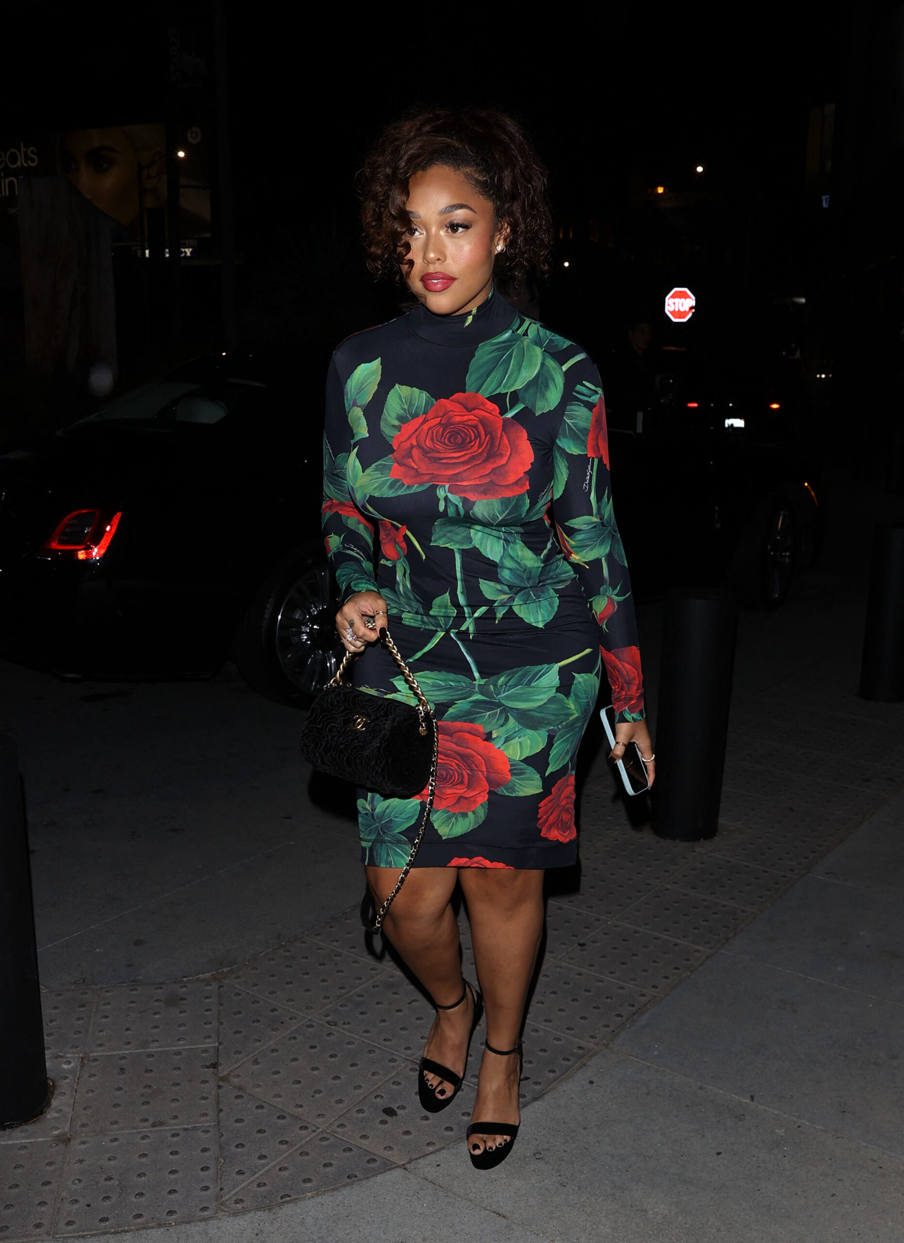 Jordyn Woods stuns in a Rose patterned dress as she steps out of a Rolls Royce for dinner at 'Madeo' Restaurant in West Hollywood, CA