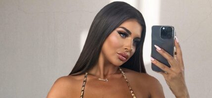 Larissa Trownson takes a selfie in a striped bikini