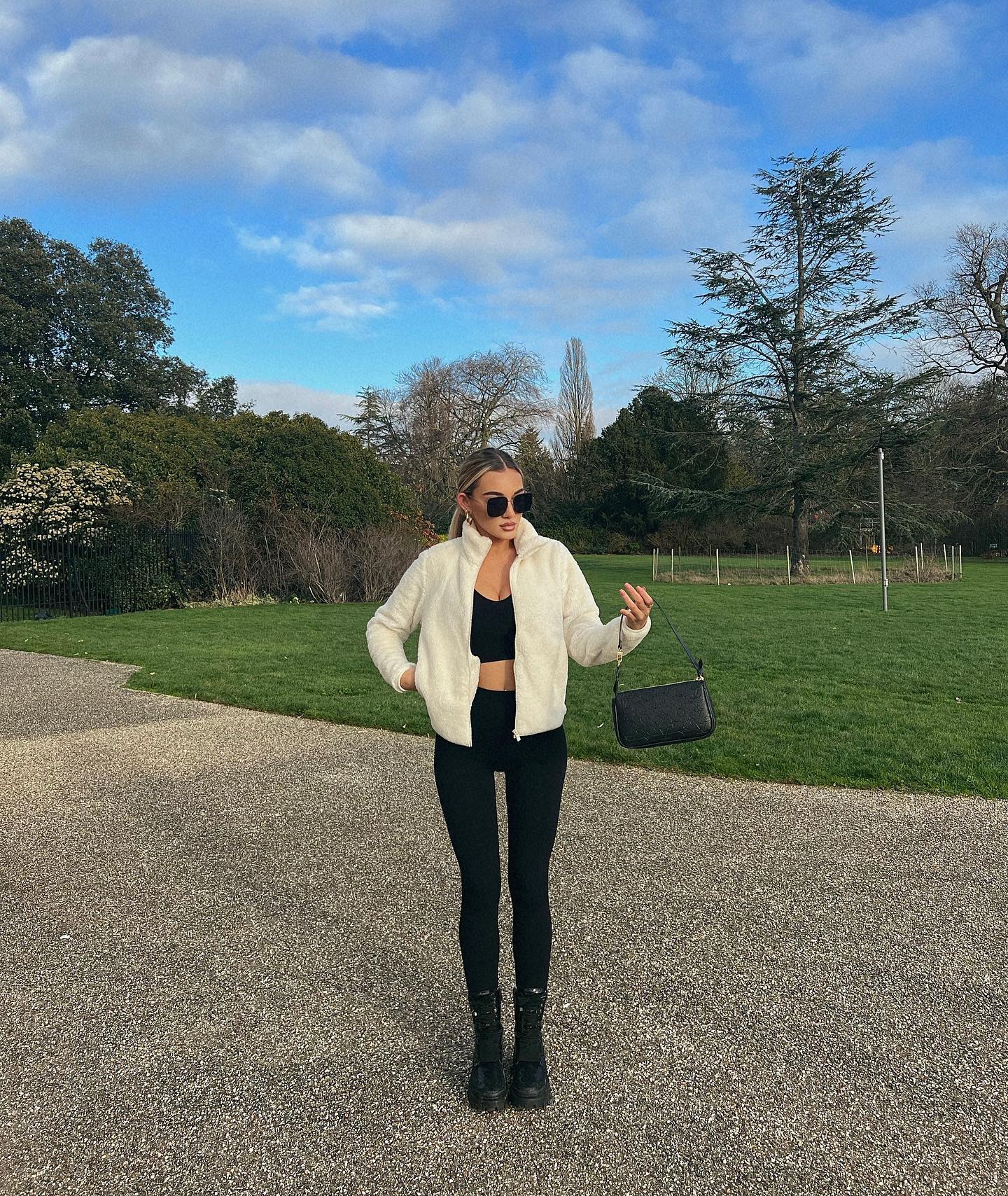 Beaux Raymond in a black crop top and white jacket