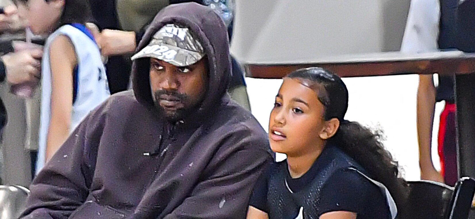 Kanye West with Daughter North West at a basketball game