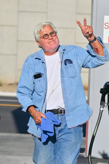 Jay Leno stops by a gas station in yet another cool car after getting out of the hospital yesterday