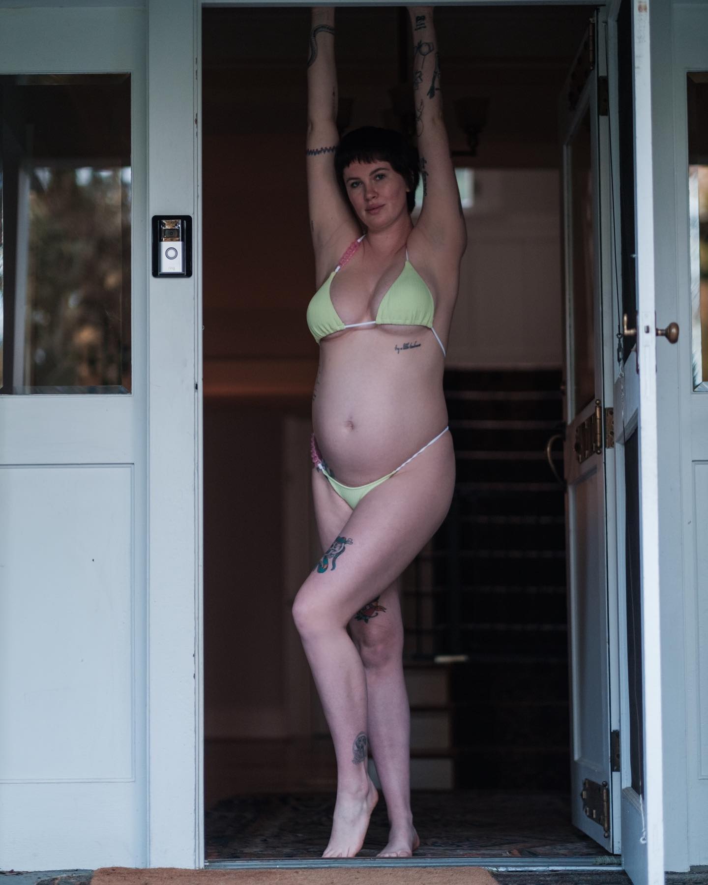 Ireland Baldwin marks the 6 month mark of her first pregnancy posing in a green bikini