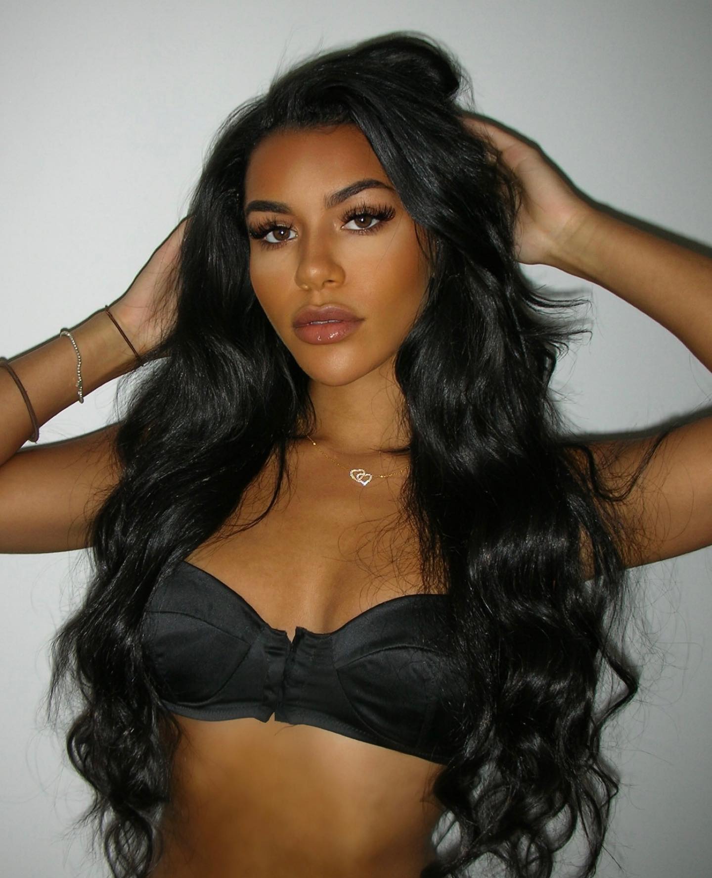 Izzy Fairthorne poses in a black bra