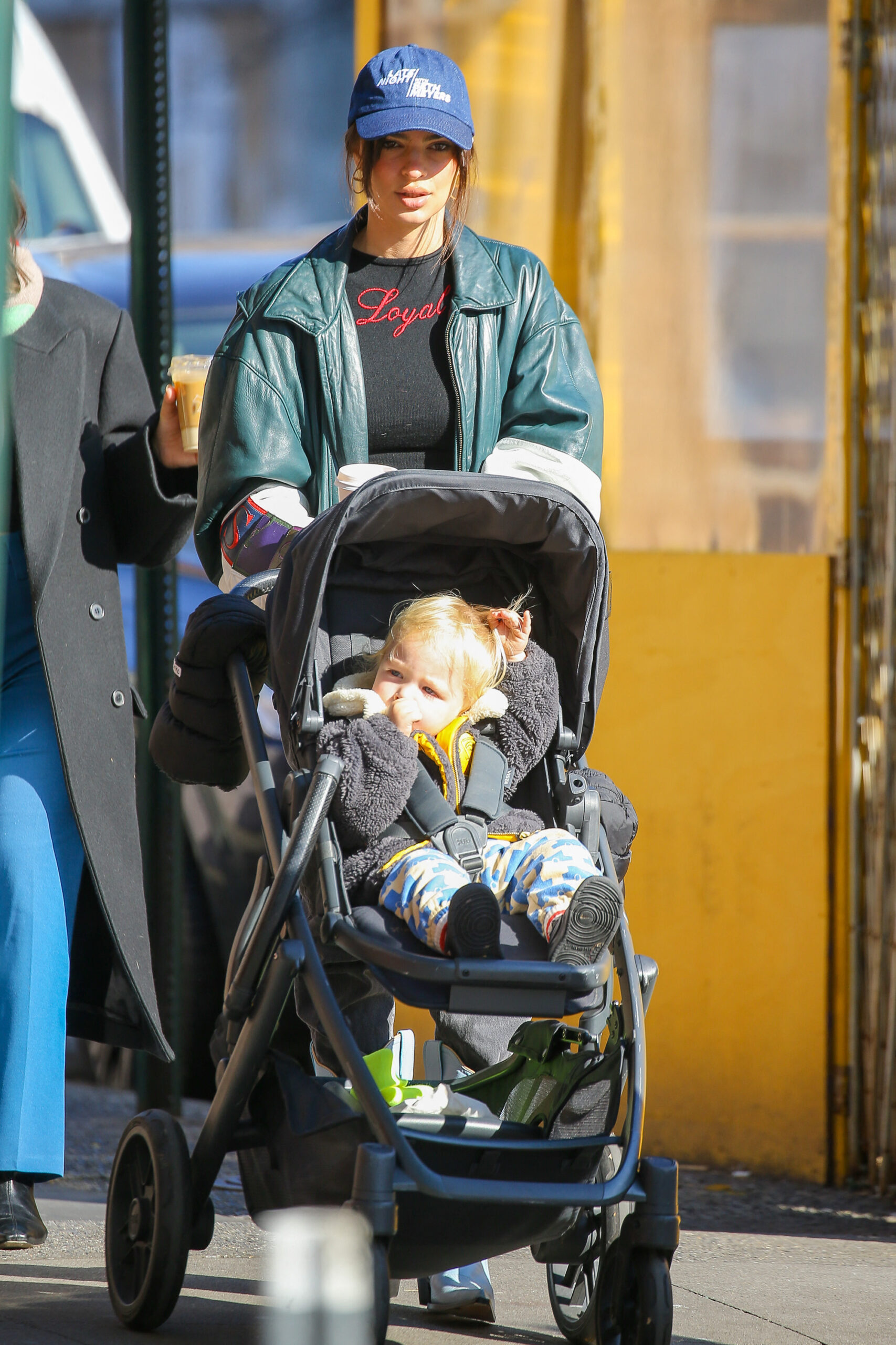 Emily Ratajkowski is seen out for a walk pushing her son in a stroller and picking up a coffee in NYC
