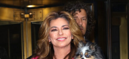 Shania Twain is pretty in pink and carries her pet dog as she leaves The Today Show in NYC