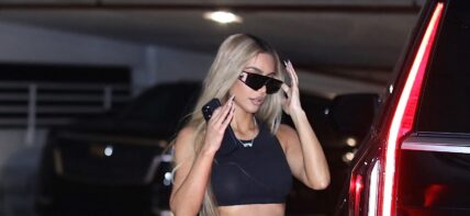 Kim Kardashian gives the peace sign as she heads out to a party with Khloe Kardashian and Jonathan Cheban in Miami