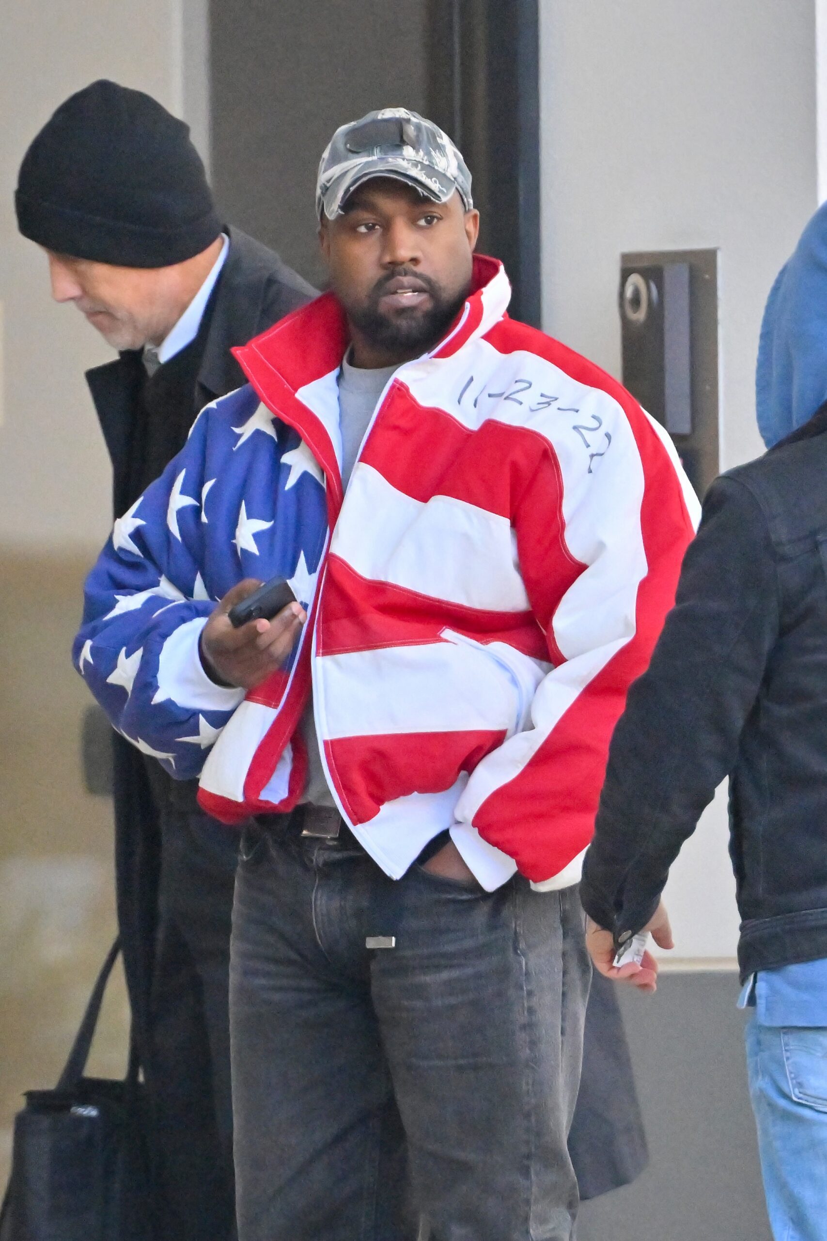 Kanye West heads to a meeting after heading to church wearing an American flag jacket