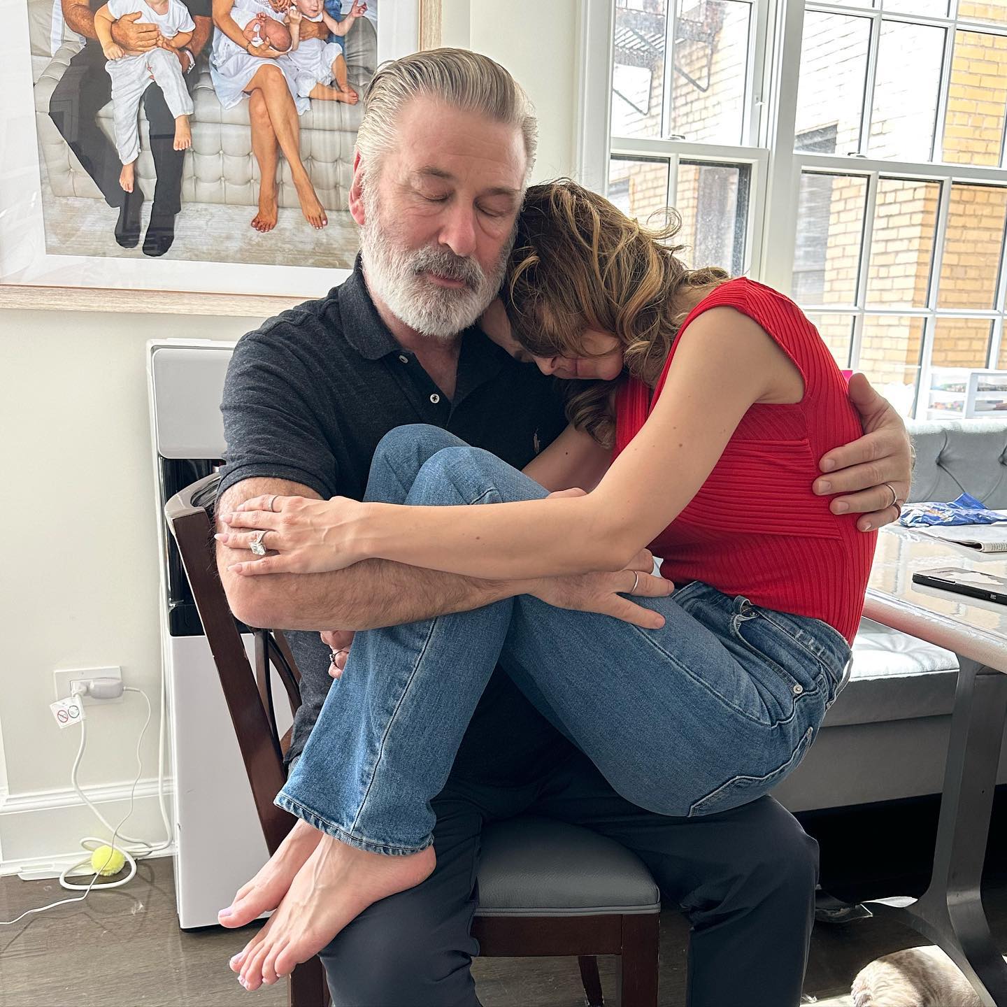 Alec Baldwin holding Hilaria Baldwin