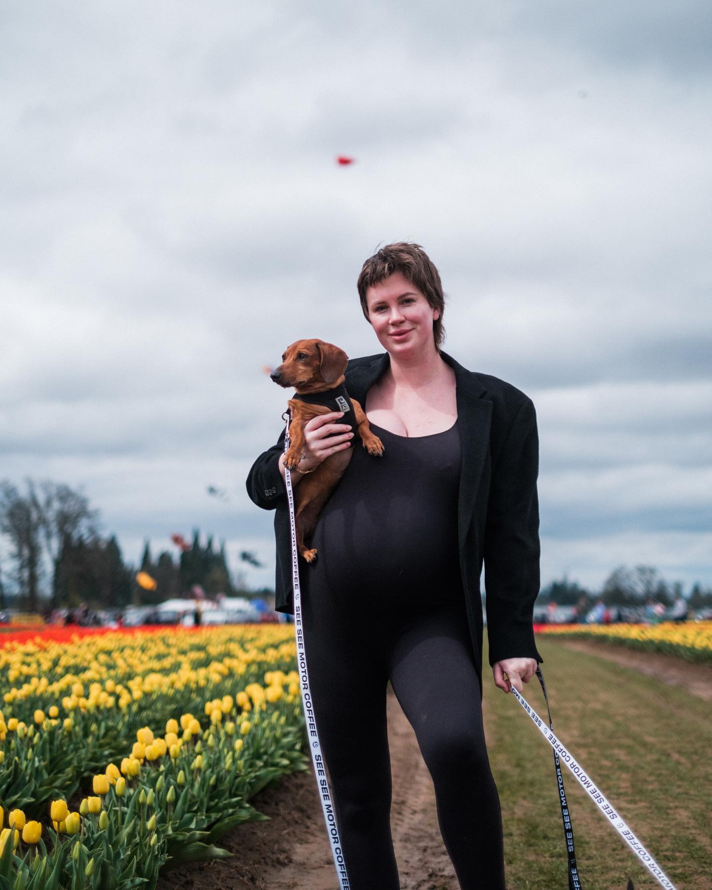 Ireland Baldwin poses with her dogs at the fair