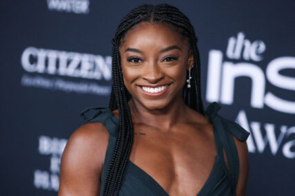 Simone Biles wearing an Aliette dress, Christian Louboutin shoes, and Matteo jewelry while carrying a Judith Leiber bag arrives at the 6th Annual InStyle Awards 2021