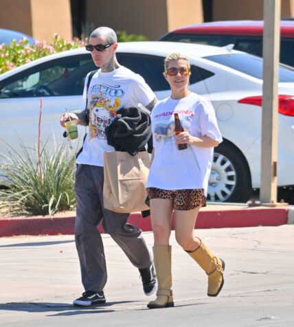 Kourtney Kardashian and husband Travis Barker are all smiles as they leave a vegan restaurant in Palm Desert after celebrating their 1st wedding anniversary