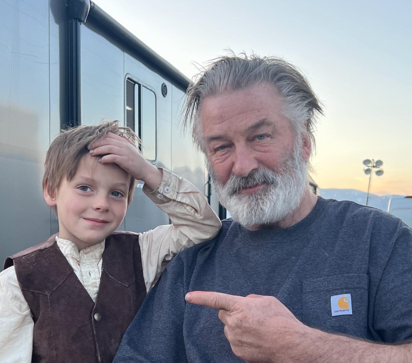 Alec Baldwin poses on 'Rust' set with Easton Malcolm