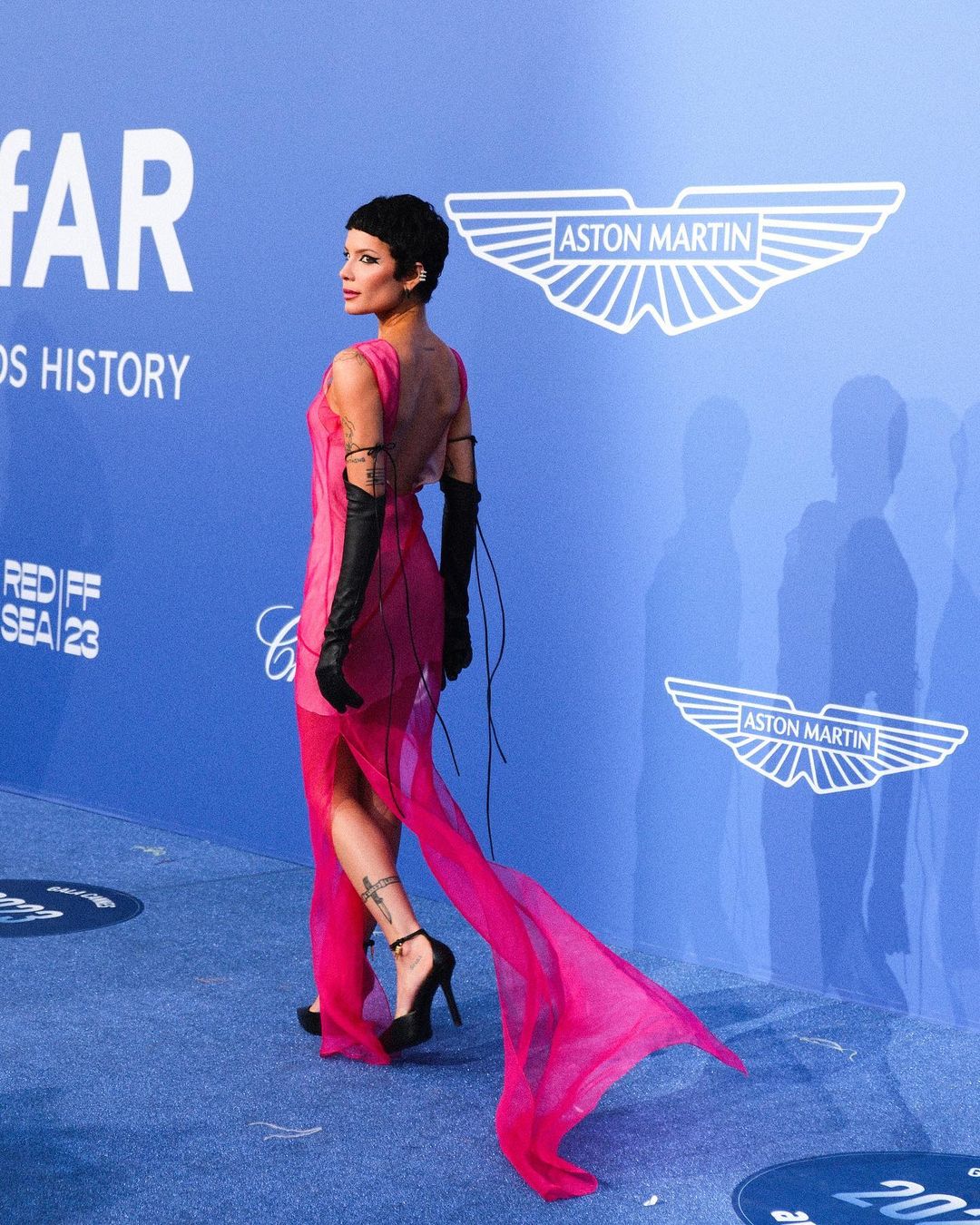 Halsey in neon pink dress at amfAR