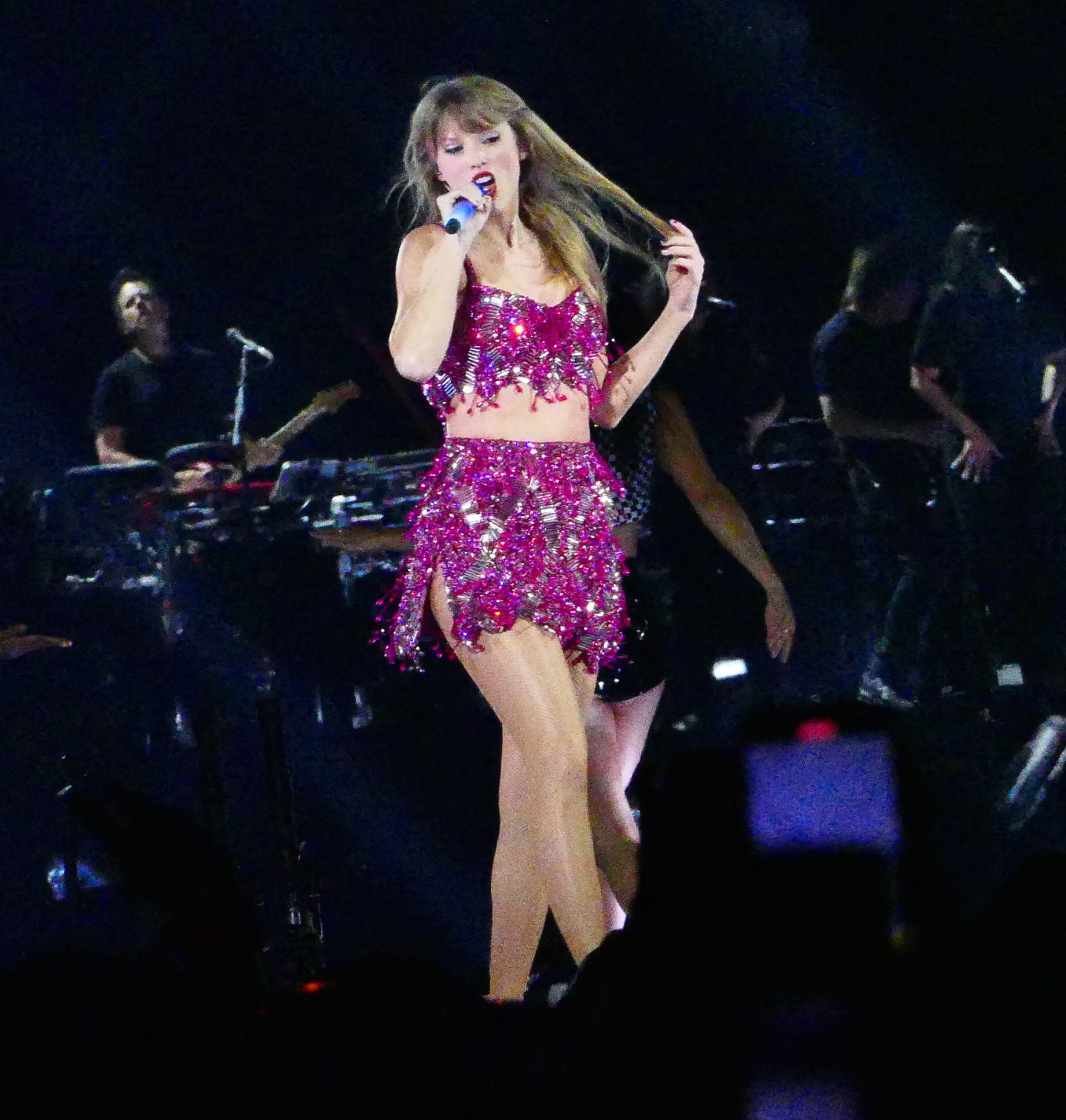 Taylor Swift holds a light saber style prop as bicycles and cars go by her in amazing visual show on stage during first weekend of her tour in Arizona