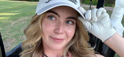 Grace Charis poses in a pink crop top