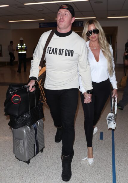 Kim Zolciak makes a sexy arrival as she is spotted at LAX with husband Kroy