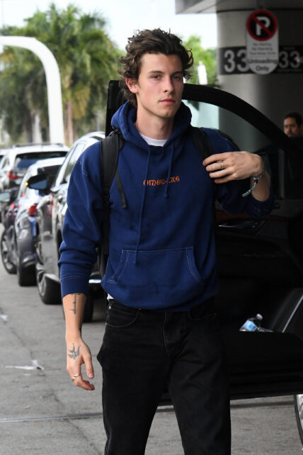 Singer Shawn mendes wraps up his Miami vacation as he is seen wearing a blue hoodie and black jeans at the Miami International Airport