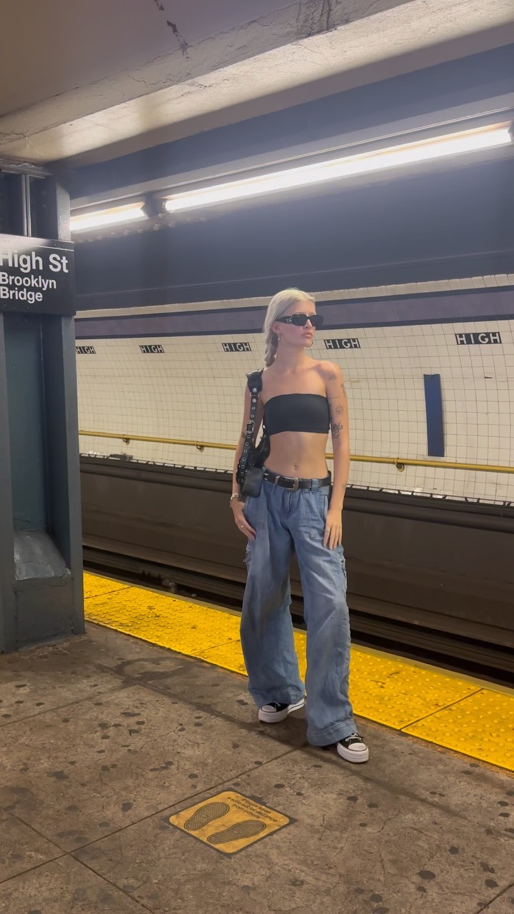 Sami Sheen poses in a black bandeau top