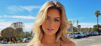 Emily Elizabeth poses for the camera in her black bikini top and denim shorts.