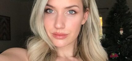 Paige Spiranac takes a selfie in a low-cut yellow top.