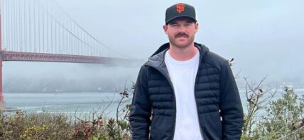 Grayson Murray posing in front of a bridge