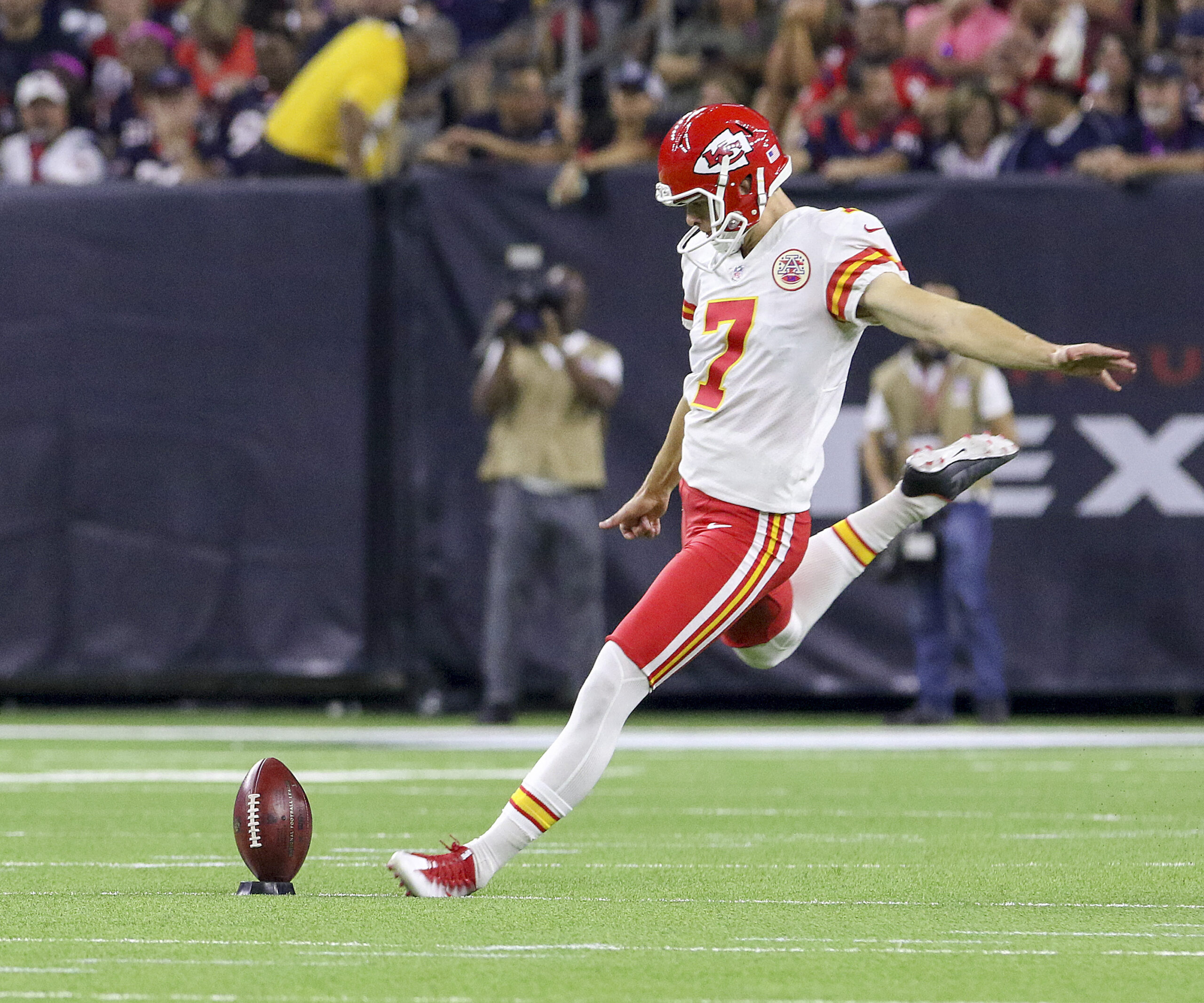 Harrison Butker kicking the football